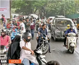  ??  ?? Motorists take shelter under the PVNR Express Way during a drizzle in Mehdipatna­m on Sunday. — R. PAVAN