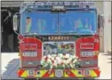  ??  ?? Kennett Fire Company’s new firetruck sits adorned with flowers waiting to be housed.