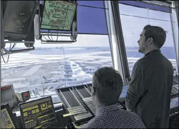  ?? SETH WENIG / AP ?? Air traffic controller­s work at John F. Kennedy Internatio­nal Airport in New York on Thursday. President Donald Trump is calling for privatizin­g the nation’s air traffic control operations in his budget, a top priority of the airline industry.