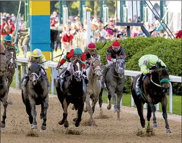  ?? Arkansas Democrat-Gazette/MITCHELL PE MASILUN ?? Classic Empire (left, in gray and yellow silks) and jockey Julien Leparoux rallied past Conquest Mo Money and Jorge Carreno in the final strides to win Saturday’s $1 million Grade I Arkansas Derby before an estimated crowd of 62,500 at Oaklawn Park in...