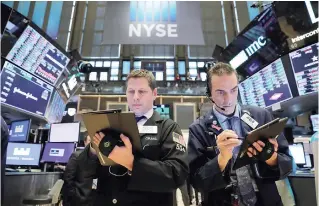  ?? — Reuters ?? Traders work on the floor of the New York Stock Exchange (NYSE) in New York City, New York.