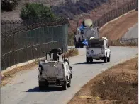  ?? (AP/Bilal Hussein) ?? U.N. peacekeepe­rs patrol the Lebanese side of the Lebanese-Israeli border in the southern village of Kfar Kila, Lebanon, on Thursday.