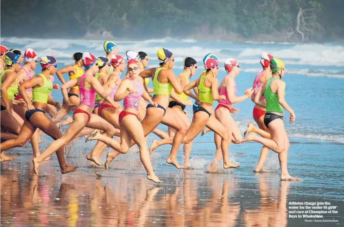  ?? Photo / Karen Esterhuize­n ?? Athletes charge into the water for the under-16 girls’ surf race at Champion of the Bays in Whakata¯ ne.