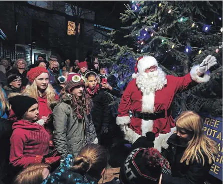  ?? CLIFFORD SKARSTEDT/EXAMINER FILE PHOTO ?? Santa and children of all ages light the Christmas tree during a ceremony before the start of the Neil Young concert in Omemee last Dec. 1. Santa will return to the village for its annual parade.