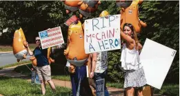  ?? Samuel Corum / New York Times ?? As Sen. John McCain was eulogized Saturday in Washington, D.C., demonstrat­ors rallied outside President Trump’s golf resort in Sterling, Va.