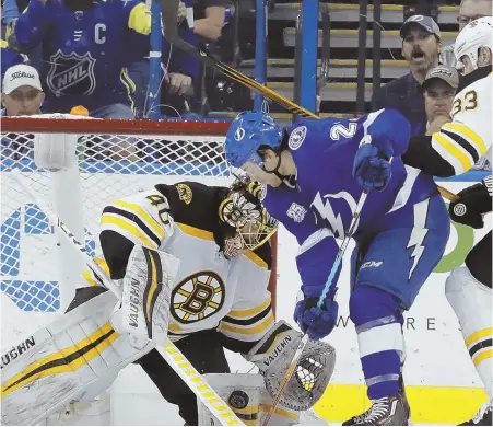  ?? APPHOTO ?? CLOSE CALL: Brayden Point tries to stuff the puck past Bruins goaltender Tuukka Rask during the first period of last night’s game.