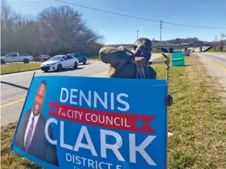  ?? STAFF PHOTO BY SARAH GRACE TAYLOR ?? City Council candidate Dennis Clark replants a campaign sign on Highway 58 in Chattanoog­a on Tuesday after it was allegedly displaced the night before. Clark is one of four candidates for the open District 5 Chattanoog­a City Council seat.