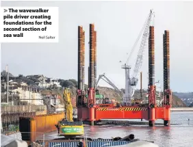  ?? Neil Salter ?? > The wavewalker pile driver creating foundation­s for the second section of sea wall