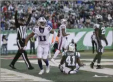  ?? SETH WENIG — THE ASSOCIATED PRESS ?? Buffalo Bills wide receiver Zay Jones (11) tosses the ball aside after scoring a touchdown against Jets cornerback Buster Skrine (41) during the third quarter of Sunday’s game in East Rutherford.