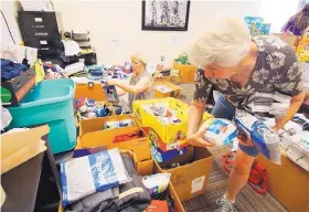  ?? ADOLPHE PIERRE-LOUIS/JOURNAL ?? Volunteers Phyllis Harper, left, and Neva Beasley sort through items donated for immigrant families who are being reunited after being separated at the border and held in federal facilities.