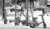  ?? JOE BURBANK/ORLANDO SENTINEL ?? Different brands of scooters are parked on the sidewalk in front of the Orange County Administra­tion building in downtown Orlando.