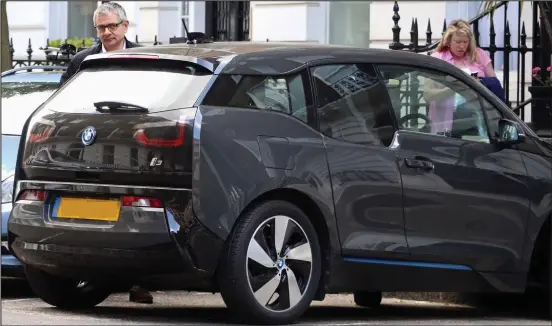  ??  ?? City runaround: The Mr Bean star stands next to his electric BMWi3, which costs £30,000 and reaches 93mph, in central London