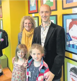  ??  ?? Hermione Harper from Egerton Primary School is joined by her family to proudly showcase her portrait