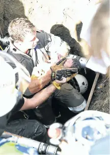  ?? Picture: Jackie Clausen ?? Rescue workers hold the baby they rescued from a stormwater drain where she was left by her mother .