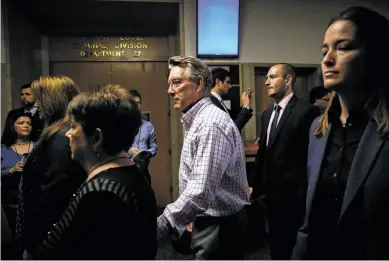  ?? Photos by Gabrielle Lurie / The Chronicle ?? Kate Steinle’s parents, Liz Sullivan (black shirt, short hair, left) and Jim Steinle (checked shirt, center), make their way through the Hall of Justice on the day of closing arguments in the trial in their daughter’s slaying.