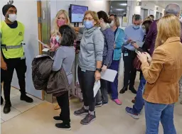  ?? — AFP ?? Staff volunteers queue to receive a fourth dose of the Pfizer-BioNTech Covid-19 vaccine at the Sheba Medical Centre in Ramat Gan, Israel, on Monday.