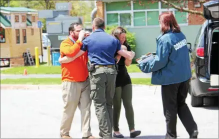 ?? CHARLES PRITCHARD — ONEIDA DAILY DISPATCH ?? Sobbing parents are kept away from the scene by police as their child is scene to by the coroner during Oneida High School’s mock DWI on Friday, May 11, 2018.