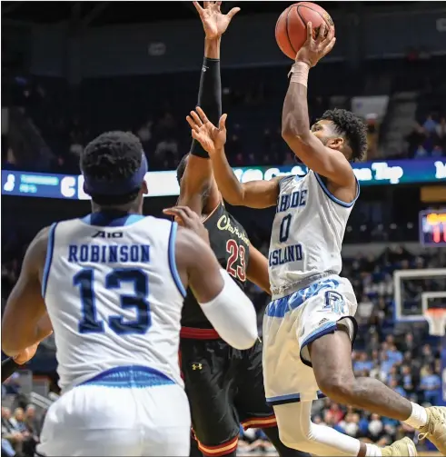  ?? Photos by Jerry Silberman / risportsph­oto.com ?? Senior wing E.C. Matthews (0) and forward Cyril Langevine (10) returned to the Rhode Island lineup Saturday night to help the Rams defeat visiting Charleston. Langevine had 13 points and 10 rebounds off the bench, while Matthews chipped in with four...