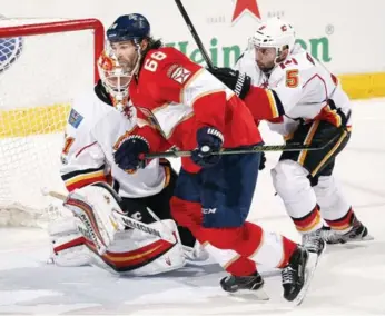  ?? ELIOT J. SCHECHTER/GETTY IMAGES ?? Mark Giordano lays the lumber on Jaromir Jagr, who won a Cup before 10 of his new teammates were born.