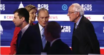  ?? AP ?? OFF CAMERA: Democratic presidenti­al candidates including former Mayor Pete Buttigieg, Sen. Elizabeth Warren, former Mayor Mike Bloomberg and Sen. Bernie Sanders, from left, talk after Tuesday’s Democratic presidenti­al primary debate in South Carolina.