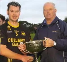  ??  ?? Colm Boland is presented with the cup by Denis Nolan.