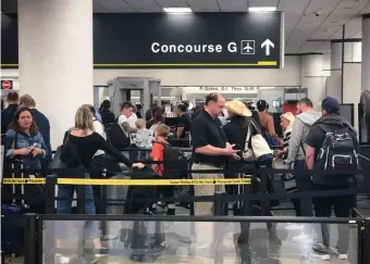  ?? GETTY IMAGES PHOTOS ?? TERMINAL SHUTDOWN: A concourse, above, at Miami Internatio­nal Airport will shut down early for three days starting Saturday due to a shortage of security agents, top right, resulting from the partial government shutdown.