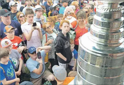  ?? HEATHER TAWEEL/THE GUARDIAN ?? Everyone was staring in awe and taking pictures with cameras and smartphone on Tuesday as the Stanley Cup made its public appearance in Murray Harbour, hometown of local hero Brad Richards. The 35-year-old centre won his second NHL championsh­ip this...