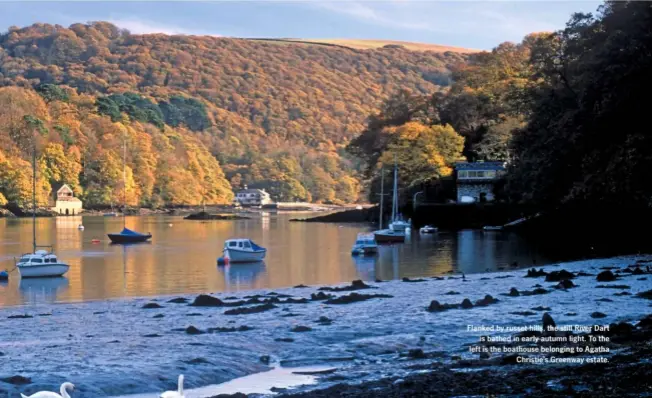  ??  ?? Flanked by russet hills, the still River Dart is bathed in early autumn light. To the left is the boathouse belonging to Agatha Christie’s Greenway estate.