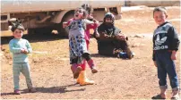  ?? (Khalil Ashawi/Reuters) ?? SYRIAN CHILDREN play near the Syrian border with Turkey last week.