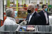  ?? PATRICK SEMANSKY — THE ASSOCIATED PRESS ?? President Joe Biden talks with a volunteer at the Houston Food Bank in Houston on Friday.