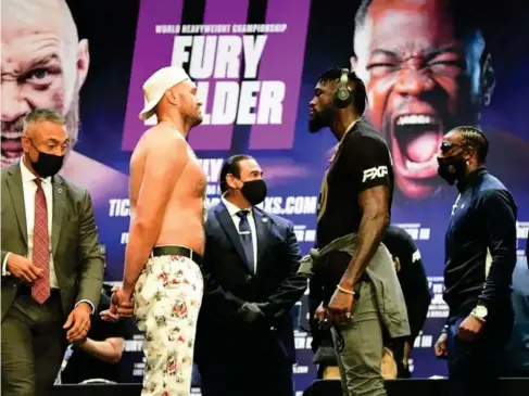  ?? (AFP/Getty) ?? Fury and Wilder face - off at a Los Angeles press conference