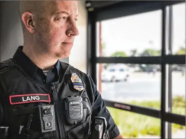  ?? JIM NOELKER / STAFF ?? Englewood police Sgt. Mike Lang wears a WatchGuard body camera. The Montgomery County Sheriff’s Office received initial approval by a county board to purchase 200 units of the same model.