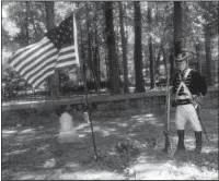  ?? Submitted photo ?? PRESERVING HISTORY: Jimmie Weber stands guard at the grave of the War of 1812 soldier Ludovicus Belding, located in the Bassett-Belding-Gaines Cemetery.