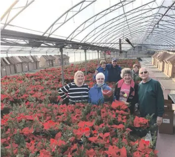  ?? —supplied photo ?? Maison Interlude House raised more than $25,000 with its annual poinsettia sale to help support programs that aid women dealing with abusive situations. Gathered for a photo are volunteer coordinato­r Nancy Charbonnea­u (front left) with volunteers Lucie Campbell, Rebecca Caplan, and André Peloquin. Behind are Michelle and André Guindon and Line Desjardins.