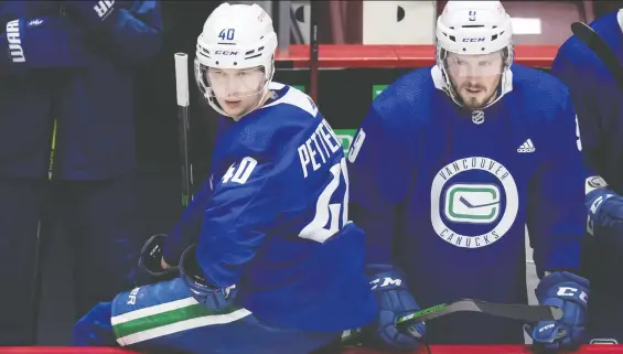  ?? THE CANADIAN PRESS ?? Canucks forwards Elias Pettersson, left, and J.T. Miller will soon reunite on the Lotto Line with Brock Boeser as Miller returns from quarantine for tonight's game.