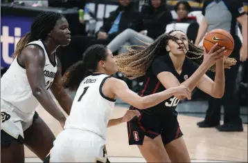  ?? DAVID ZALUBOWSKI — THE ASSOCIATED PRESS ?? Stanford guard Haley Jones, right, drives to the basket as Colorado guard Tayanna Jones, center, and center Aaronette Vonleh defend in the first half on Thursday in Boulder, Colo.