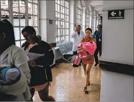  ??  ?? VENEZUELAN Juberkis Alvarez Guanipa, 19, carries her newborn after being discharged from Hospital Materno Infantil in Bogota, Colombia.