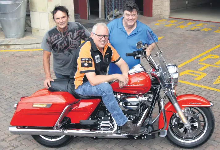  ??  ?? THE HARLEYS. Gold Rand Harley bossman Pierre Delport sits on a machine you could ride for free this Saturday. He is flanked by stuntmen Enrico Schoeman (left) and André de Kock.