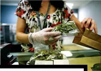  ??  ?? MONEY CHANGES EVERYTHING A sales associate at Good Meds, a medical cannabis center in Lakewood, Colorado. Sales reached $9 billion in the U.S. in 2017, and could climb to $21 billion in 2021 with the addition of recreation­al markets in California and other states.