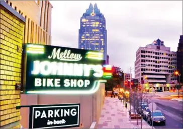  ?? DAVE MEAD/THE WASHINGTON ?? The neon signage of Mellow Johnny’s Bike Shop, which houses the Juan Pelota Cafe.