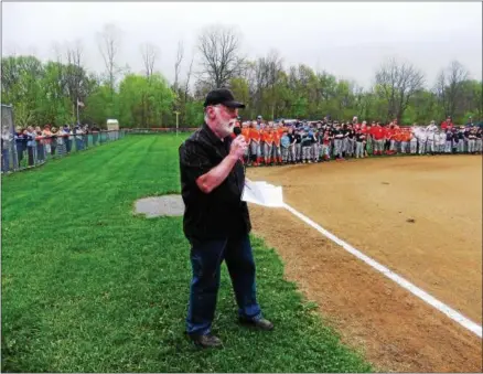 ?? PHOTO COURTESY OF DAVE BLACK ?? Mark Monroe C.A.R.E. Foundation director Dave Black addresses the crowd on the opening day of the Greater Oneida Little League season on April 29. His foundation recently donated four dugouts at Maxwell Field in Oneida to help prevent overexposu­re to...