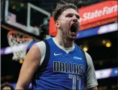  ?? MIKE STEWART — THE ASSOCIATED PRESS ?? Dallas Mavericks guard Luka Doncic (77) celebrates his shot against the Atlanta Hawks during the second half of Friday’s game in Atlanta. Doncic had 73 points on the night.