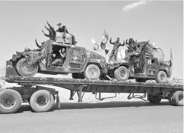  ??  ?? A handout picture shows Iraqi armoured units headed for the town of Tal Afar, the main remaining Islamic State (IS) group stronghold in the northern part of the country. — AFP photo