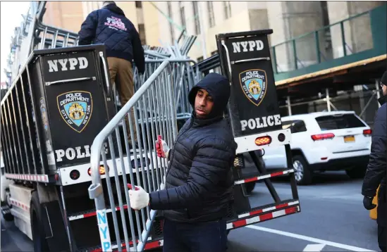 ?? MICHAEL M. SANTIAGO — GETTY IMAGES ?? NYPD drop off metal barricades in front of Manhattan Criminal Court Monday in New York City.