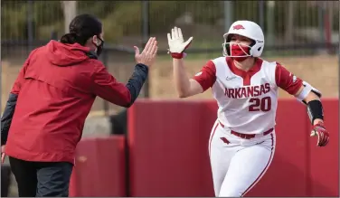  ?? (Special to NWA Democrat-Gazette/David Beach) ?? Arkansas left fielder Hannah Gammill (right) is congratula­ted by Coach Courtney Deifel after a home run during a recent game. Gammill is among a handful of players who are out for the Razorbacks as they begin a three-game set with South Carolina today.