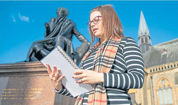  ?? Picture by Kim Cessford. ?? FITTING BACKDROP: Jena Jamieson reads one of her poems beside the statue of Robert Burns in Dundee city centre.