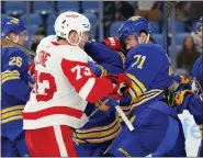  ?? JEFFREY T. BARNES — THE ASSOCIATED PRESS ?? Detroit Red Wings left wing Adam Erne (73) and Buffalo Sabres left wing Victor Olofsson (71) battle after the whistle during the second period of Monday’s game in Buffalo, N.Y.