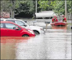  ?? J.B. FORBES / ASSOCIATED PRESS ?? Members of the High Ridge fire department take a boat in at the Village Green Estates trailer park on Monday in Cedar Hill, Mo. Torrential rains over the weekend caused flash flooding across Missouri, and as storm drains and fields continue to pour...