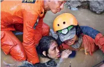  ??  ?? Rescuers try to rescue a 15-year old earthquake victim Nurul Istikharah from her damaged house following earthquake­s and tsunami in Palu on Sunday(daily Mail)