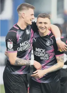  ?? ?? Posh pair Josh Knight (left) and Jack Taylor celebrate victory at QPR.